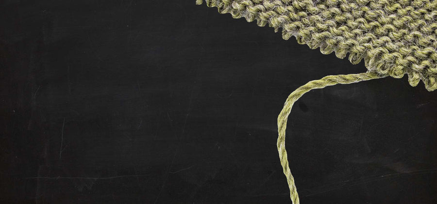 Textured green fabric on a black background